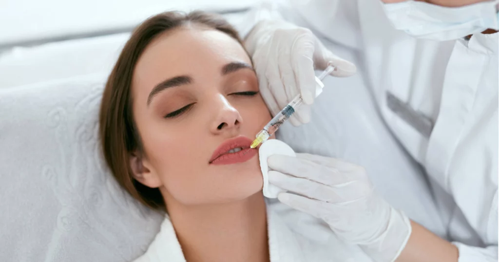 Woman receiving lip biofiller injection at aesthetic clinic in Parker, CO