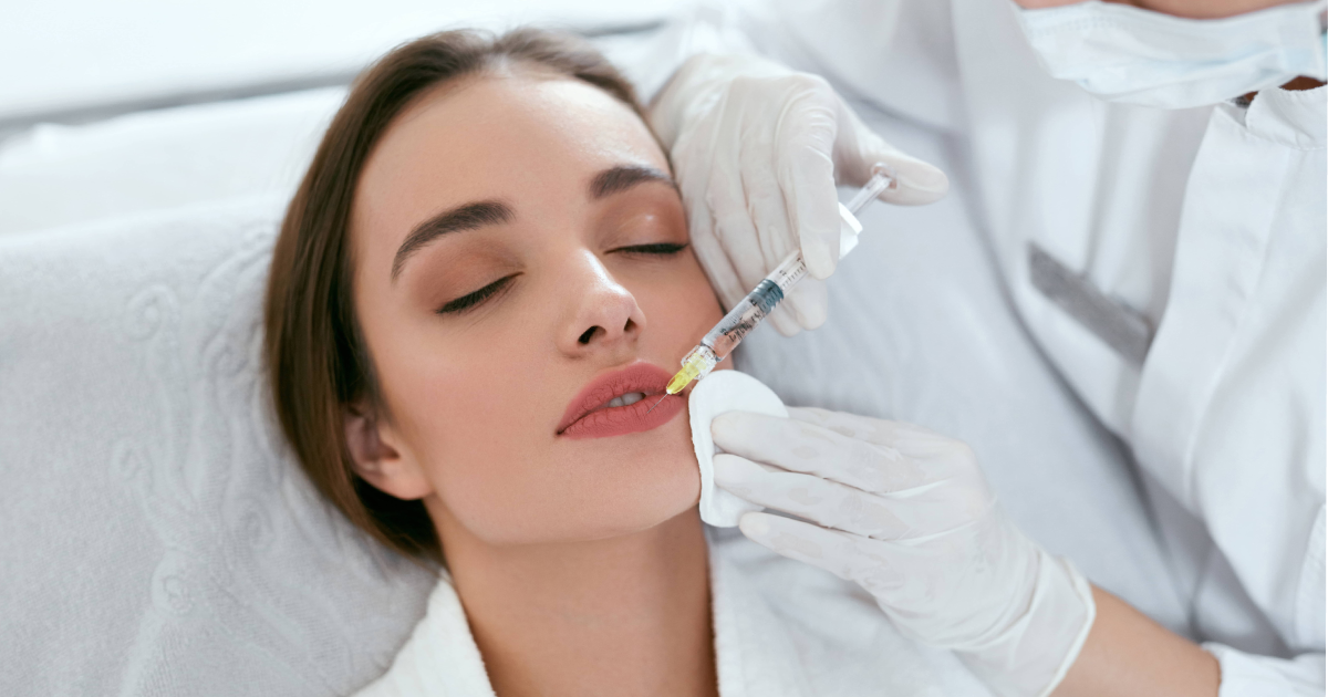 Woman receiving lip biofiller injection at aesthetic clinic in Parker, CO